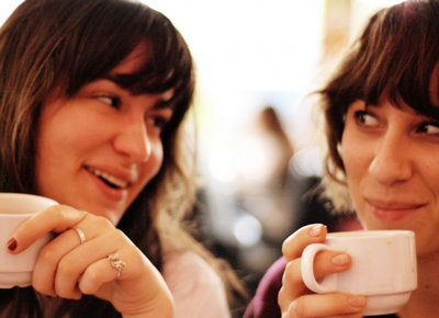 two women talking over coffee